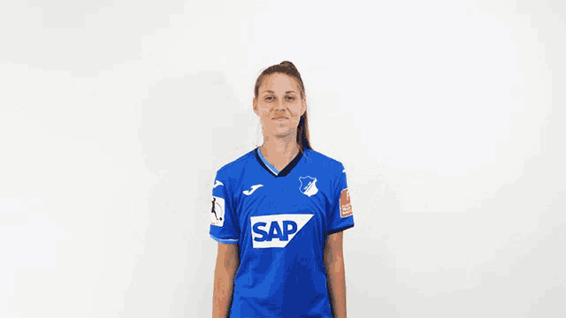 a woman in a blue shirt that says sap on it