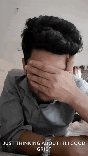 a man is covering his face with his hands and the words just thinking about it good grief