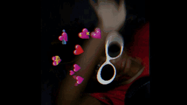 a blurry picture of a person 's face with hearts coming out of it