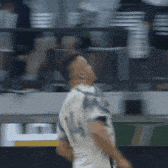a man in a white shirt with the number 14 on it