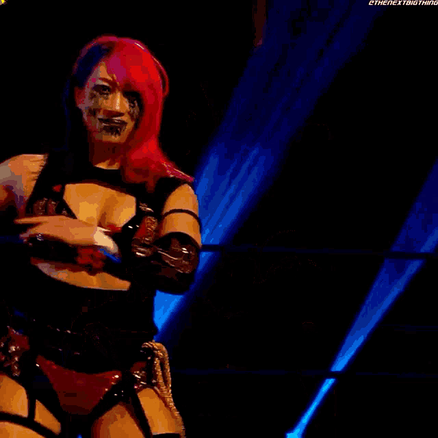 a female wrestler with tears running down her face is smiling
