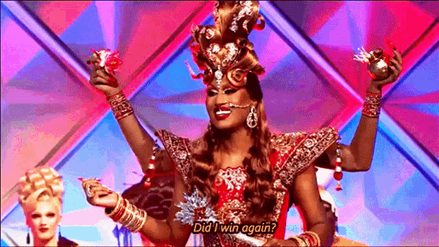 a drag queen is holding a trophy and says did i win again ?