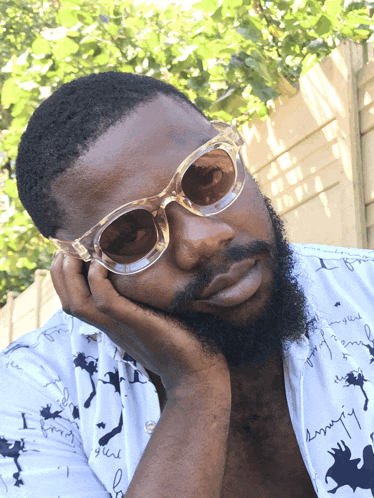 a man with a beard wearing sunglasses and a shirt that says " i love you "