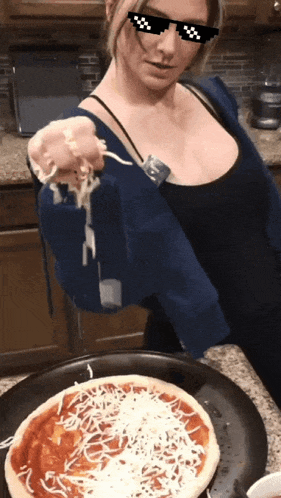a woman wearing sunglasses is putting cheese on a pizza in a pan