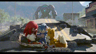 a group of stuffed animals including sonic knuckles and tails are sitting on a pile of rocks .
