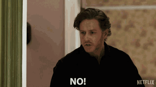 a man in a black shirt is saying no