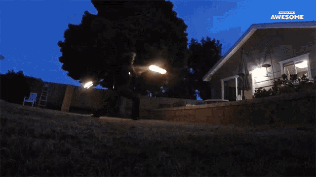 a fireworks display in a backyard with the words awesome on the bottom right