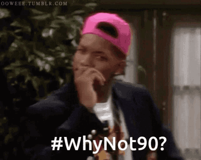 a man wearing a pink hat says # why not 90