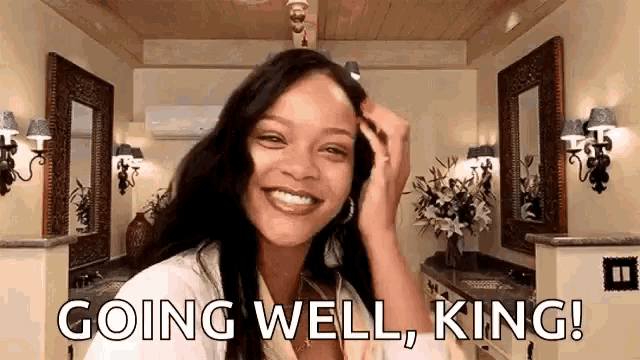 a woman is smiling in a bathroom while holding her hair and saying `` going well , king ! ''