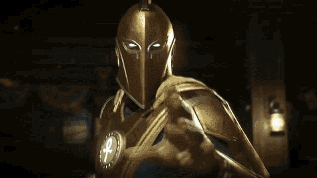 a man wearing a gold helmet with an ankh on it