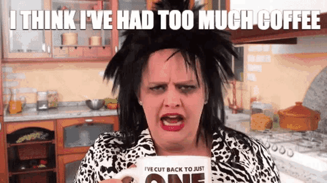 a woman is holding a mug that says " i think i 've had too much coffee "