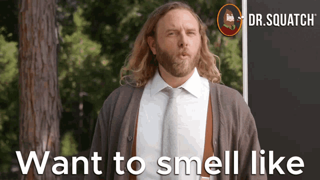 a man with long hair and a beard stands in front of a sign that says dr.squatch