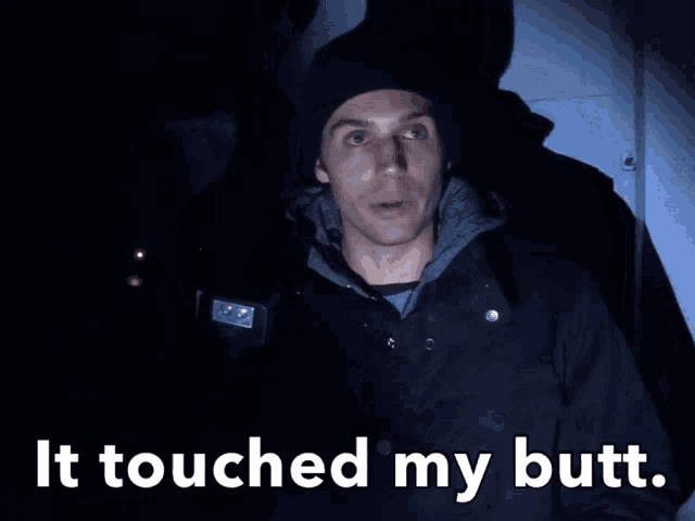 a man standing in the dark with the words it touched my butt