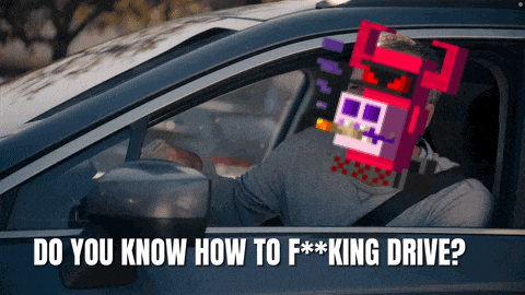 a man is sitting in a car with a cartoon character on his head and the words do you know how to f *** king drive