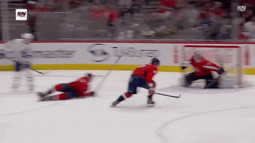 a hockey game is being played in front of a banner that says master