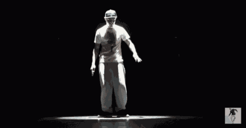 a man in a white shirt and white pants is dancing