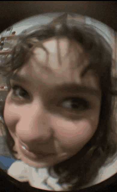 a close up of a woman 's face with a blurred background