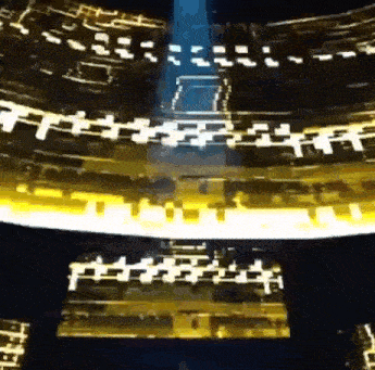 a ferris wheel with a blue light coming out of the top of it