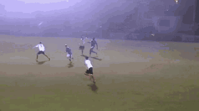 a blurry picture of people playing soccer in a field