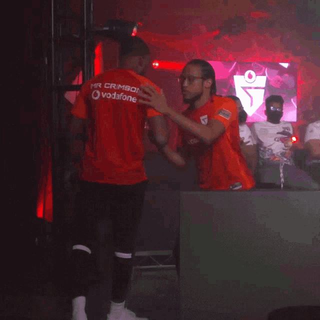 a man in an orange shirt with the word supreme on the back