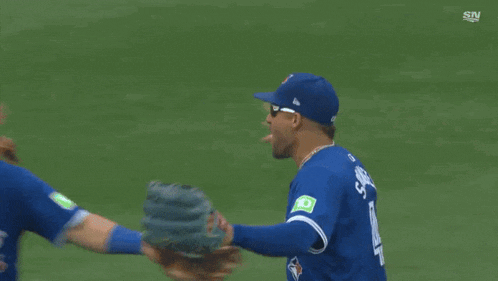 a baseball player with the number 25 on his back is hugging another player