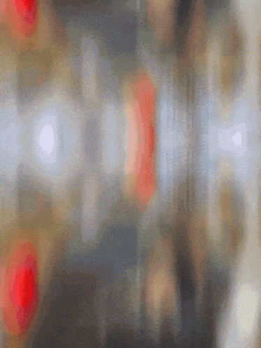 a blurred image of a room with a red balloon in the middle