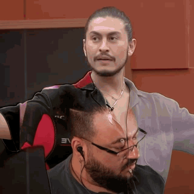 a man with a beard wearing glasses and a shirt that says eve