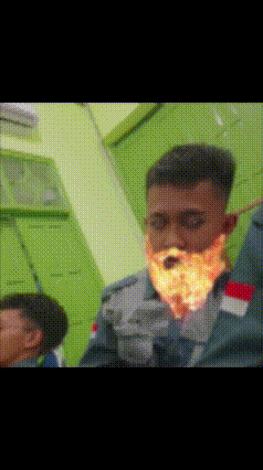 a blurry picture of a man 's face with flames coming out of it