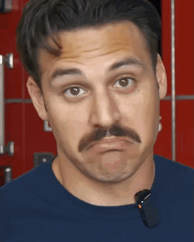 a man with a mustache is making a face