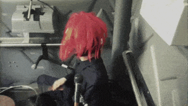 a person with red hair and a microphone