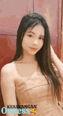 a woman in a strapless dress with the words kesayangan oncess written below her