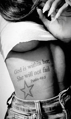 a woman has a tattoo on her back that says god is within her
