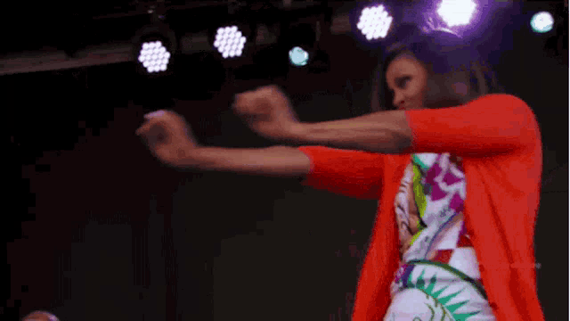 a woman is dancing in front of a screen that says #sytvcd premiere on it