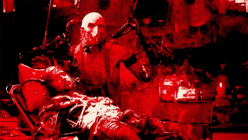 a man is laying in a hospital bed with a bloody face .
