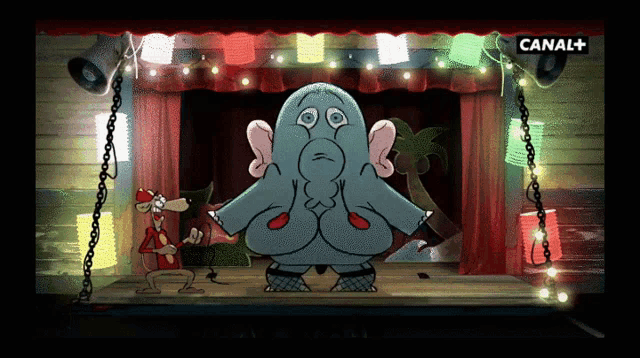 a cartoon elephant is dancing on a stage with a canal + logo in the corner