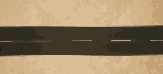 a car is driving down a road with the letter c on the side