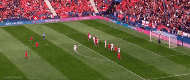 a soccer game is being played on a field that has volkswagen advertisements on the sidelines