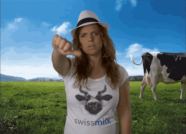 a woman wearing a swissmilk t-shirt giving a thumbs down sign