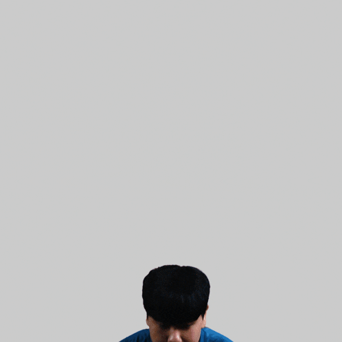 a young man wearing a blue shirt that says ashing justice
