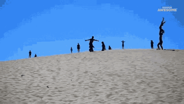 a group of people doing a handstand on top of a sand dune with the words subscribe to awesome on the bottom