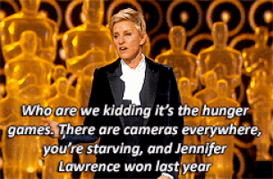 a woman in a tuxedo stands in front of oscar statues and says who are we kidding