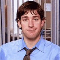 a man in a blue shirt and tie is smiling in front of a window .