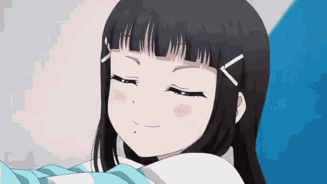 a girl with long black hair is smiling with her eyes closed
