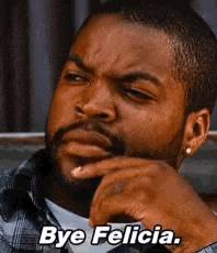 a man with a beard is sitting on a couch with his hand on his chin and says `` bye felicia '' .