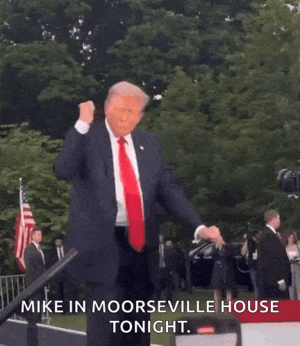 a man in a suit and tie is dancing in front of a crowd and says mike in moorseville house tonight .