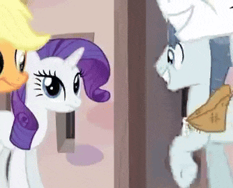a group of ponies are standing next to each other and talking to each other .