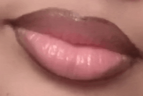 a close up of a woman 's lips with lipstick .