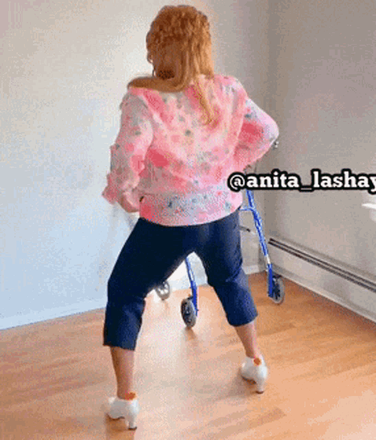 a woman is dancing with a walker in the background