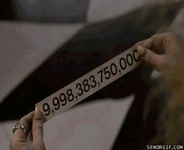 a person is holding a piece of paper that says 9,998,383,75,000