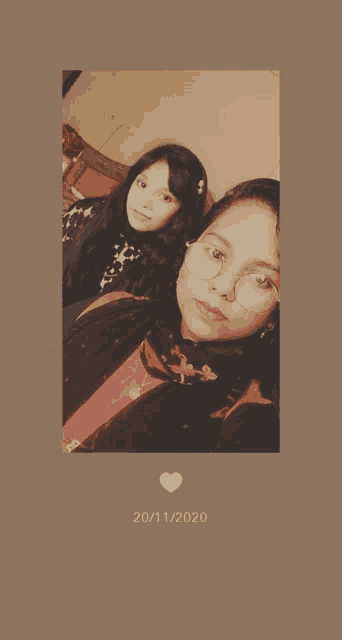two girls pose for a picture with the date 20/11/2020